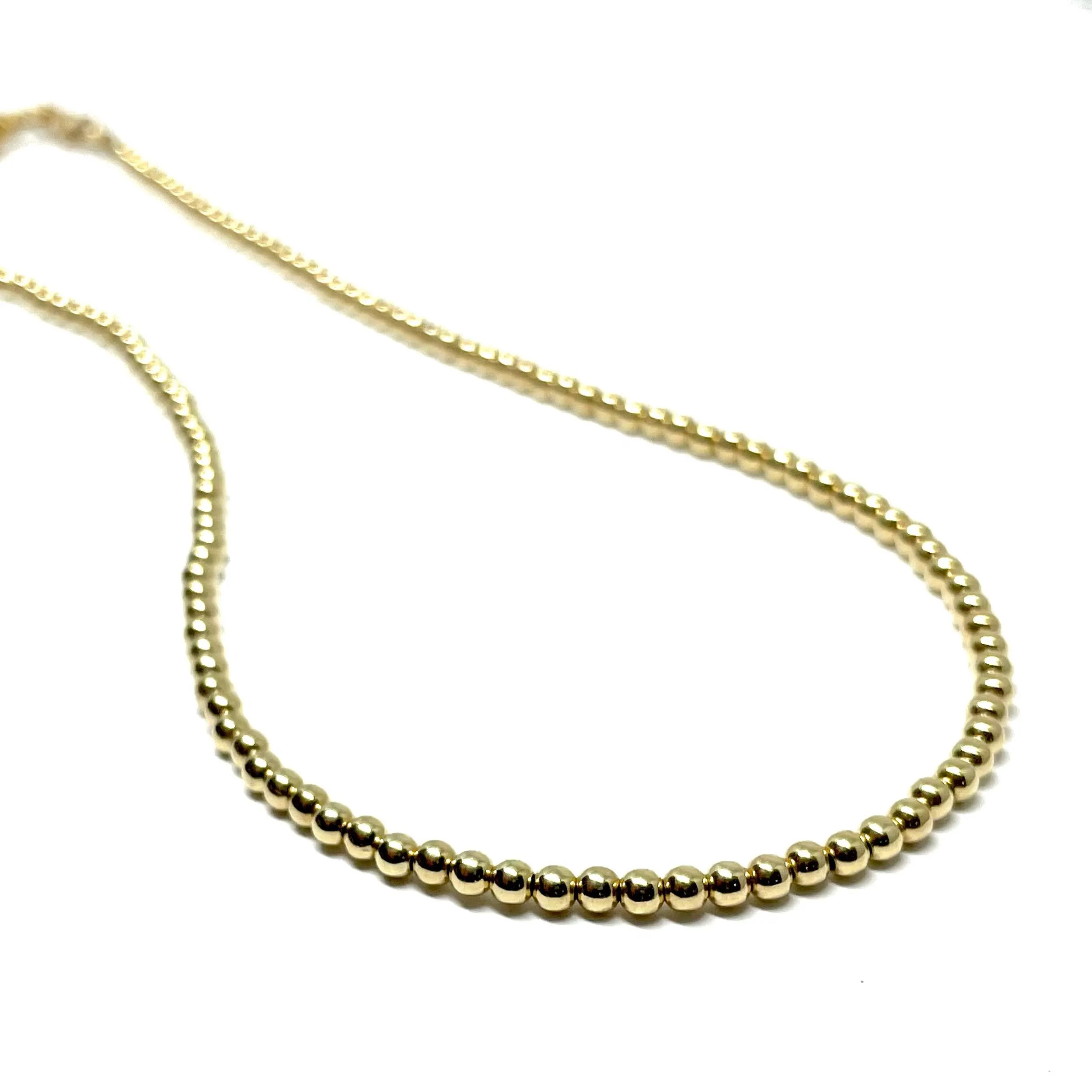 The “Aurora 3mm Gold Ball Necklace